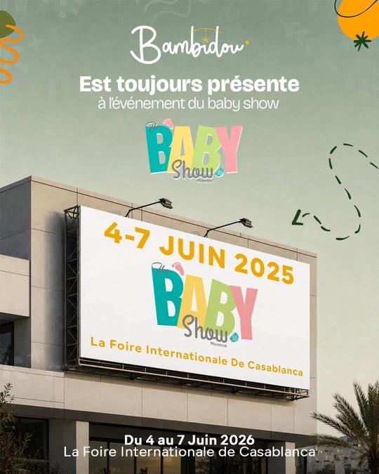 A Bambidou announcement that the brand is taking part in The Baby Show Morocco, shown as a billboard above a building carrying the event dates and the Foire Internationale de Casablanca as the venue.